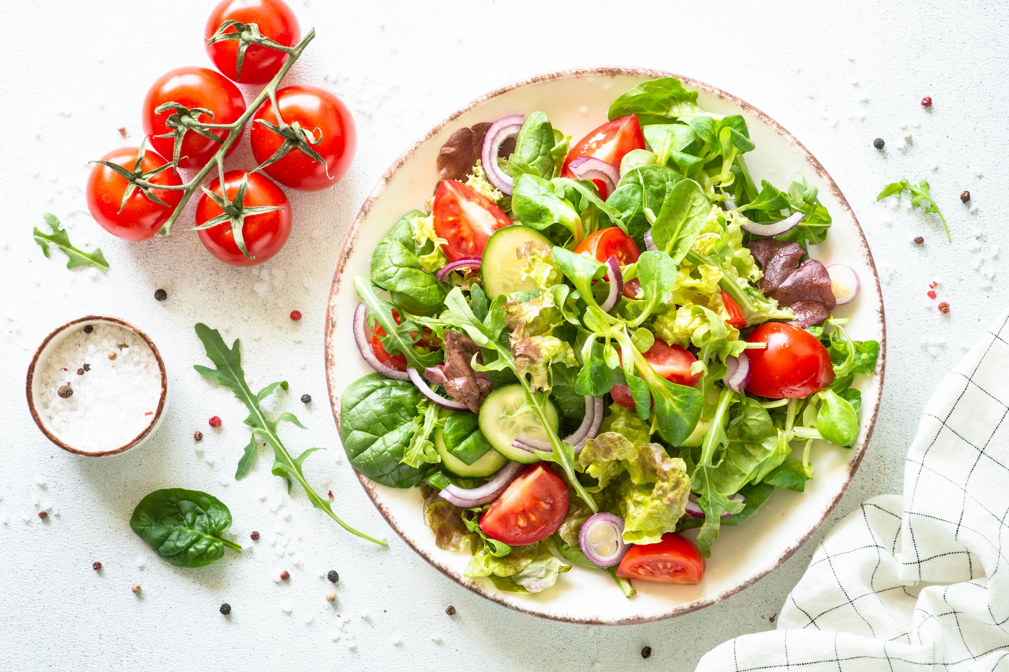 Green salad, Fresh salad leaves and vegetables in white plate.